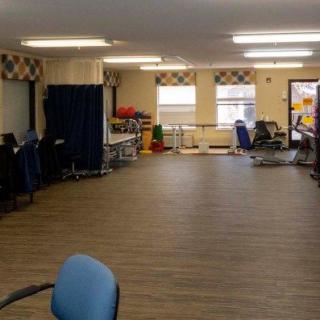 Spacious room with chairs and natural lighting.