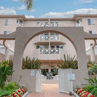 A residential building entrance with an archway and landscaped garden.