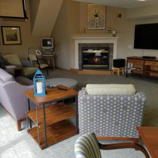 A cozy living room with a fireplace, television, and comfortable seating.