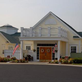 A residential building with flags displayed at the entrance.