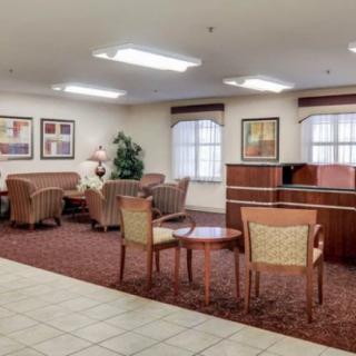 A spacious lobby with comfortable seating and a reception desk.