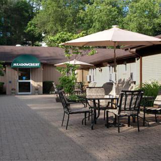 Outdoor seating area with tables and umbrellas at a restaurant.