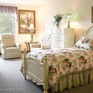 A cozy bedroom with floral decor and classic furniture.