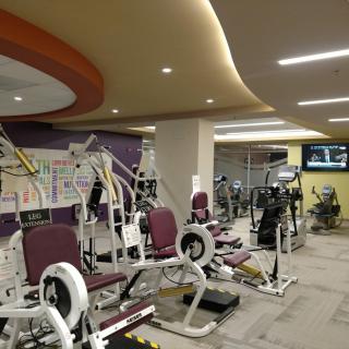 A well-equipped gym with various workout machines and exercise equipment.
