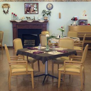 A cozy dining area with neatly arranged tables and warm decor.