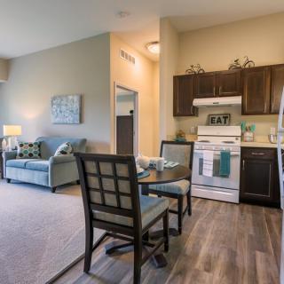 A cozy open-concept apartment featuring a kitchen, dining area, and living room.