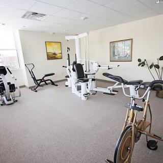 A small indoor gym with various exercise equipment.