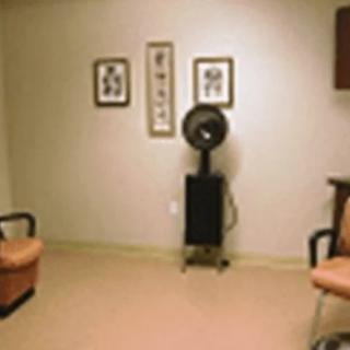 A minimalist interior room with chairs, wall art, and a hair dryer.