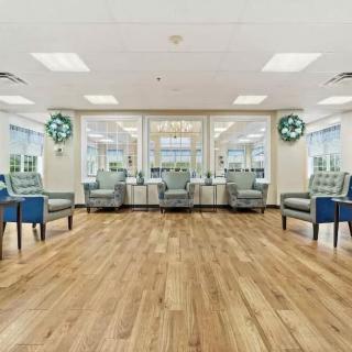 A spacious and well-lit waiting room with comfortable seating and large windows.