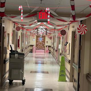 A festive hospital hallway decorated with candy-themed ornaments for the holiday season.