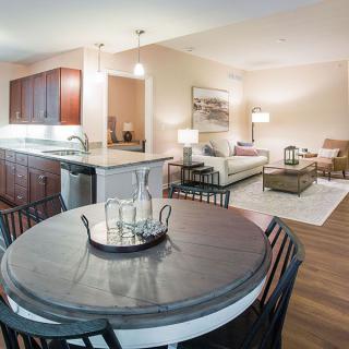 A modern open floor plan featuring a cozy living room, dining area, and kitchen with stylish decor.