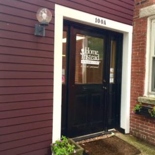 A welcoming entrance featuring a dark wooden door with a sign.