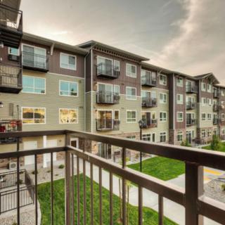 A view of a modern apartment building from the perspective of a balcony.