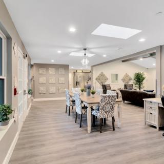 A modern open-concept living and dining area with abundant natural light and sleek wood flooring.