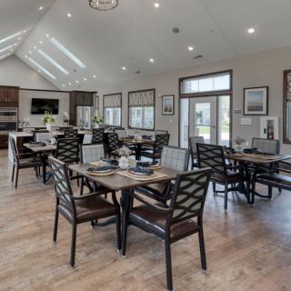 A spacious and modern dining area with neatly arranged tables and chairs.