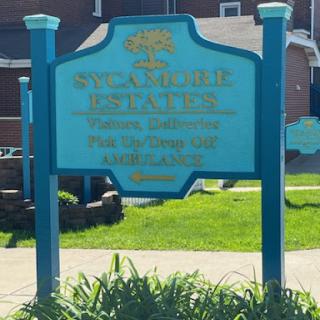 A vibrant blue sign providing information about a nearby location, set in an outdoor environment.