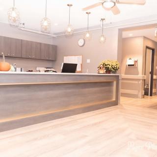 A modern reception area with a sleek desk and elegant lighting.