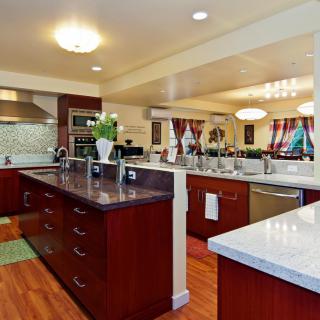 A spacious modern kitchen with an island, equipped with stainless steel appliances and elegant cabinetry.