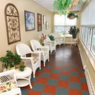 A cozy waiting area with wicker chairs and plants by the window.