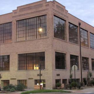 A brick office building with large windows in the evening light.