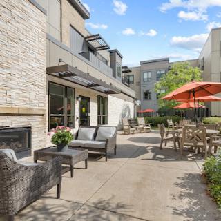 A cozy outdoor patio area featuring comfortable seating and vibrant umbrellas, perfect for relaxing on a sunny day.