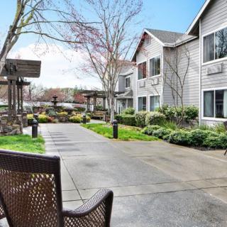 A peaceful courtyard with a walkway and benches surrounded by residential buildings.