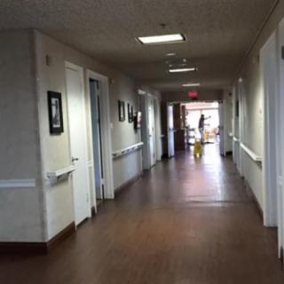 A well-lit hallway inside a building, possibly a hospital or healthcare facility.