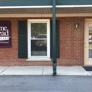 Exterior view of a commercial building featuring a brick facade and prominent signage.