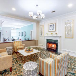 A cozy living room with a fireplace and stylish seating arrangement.