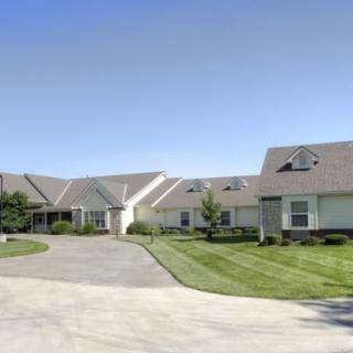 A suburban residential house with a well-maintained lawn and driveway.