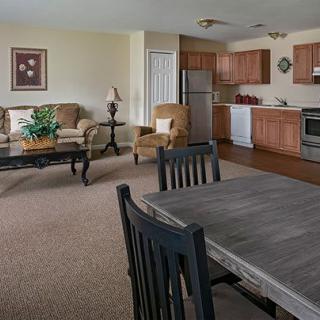 Open living and kitchen area with dining furniture and appliances.
