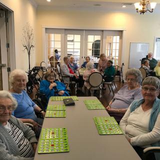 A group of seniors enjoying a game of bingo in a community center.