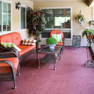 Cozy outdoor patio with wicker furniture and vibrant cushions.