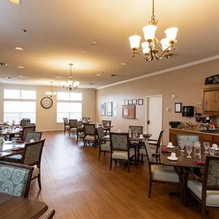 A cozy dining area with elegantly set tables and soft lighting.