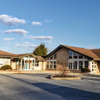 A modern architectural building set against a clear blue sky.