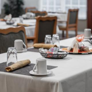 A neatly set dining table in a restaurant, prepared for breakfast service.