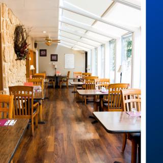 A cozy restaurant interior with wooden floors and natural lighting.