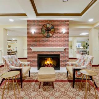 A cozy living room with a brick fireplace and comfortable seating.