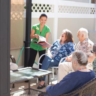 A group of people enjoying a reading session outdoors.