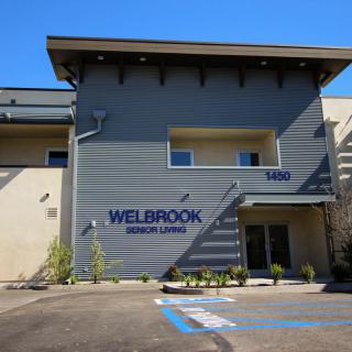 Exterior view of a commercial building with the name 'Welbrook' on the facade.