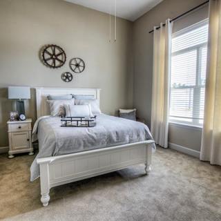 A modern and cozy bedroom with a large window and stylish decor.