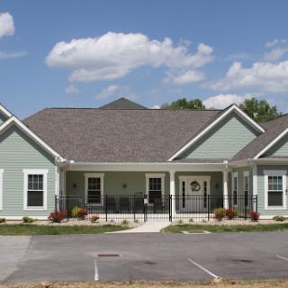 A charming residential building with a well-maintained exterior on a sunny day.