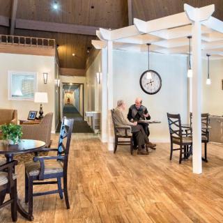 A cozy seating area with wooden flooring and comfortable furnishings.
