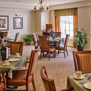 An elegantly decorated dining room with tables set for a meal.