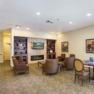 A cozy living room with a fireplace and comfortable seating arrangement.