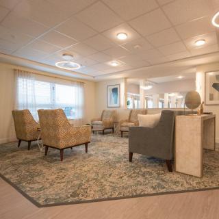 A modern waiting area with comfortable seating and soft lighting.