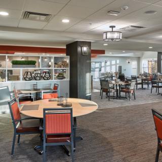 A modern restaurant dining area with neatly arranged tables and chairs.