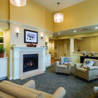 A cozy living room with a modern fireplace and comfortable seating.