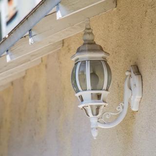 A decorative outdoor wall lantern mounted on a building.