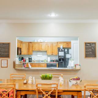A cozy kitchen and dining area with wooden furniture, featuring an open-concept design.